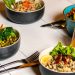 A vibrant assortment of healthy bowls and drinks showcasing fresh ingredients like broccoli and citrus.